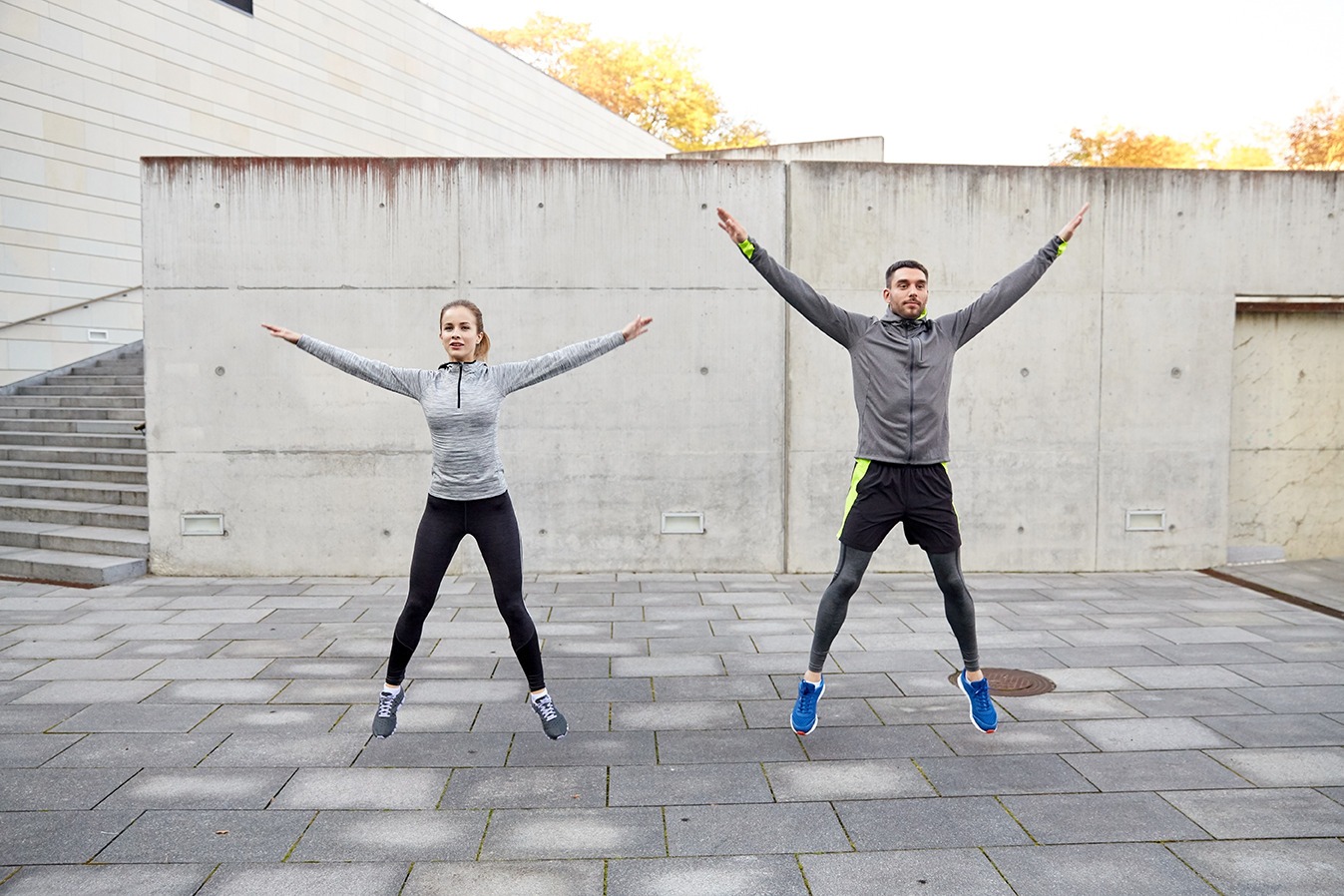 Active individual performing jumping jacks for fitness